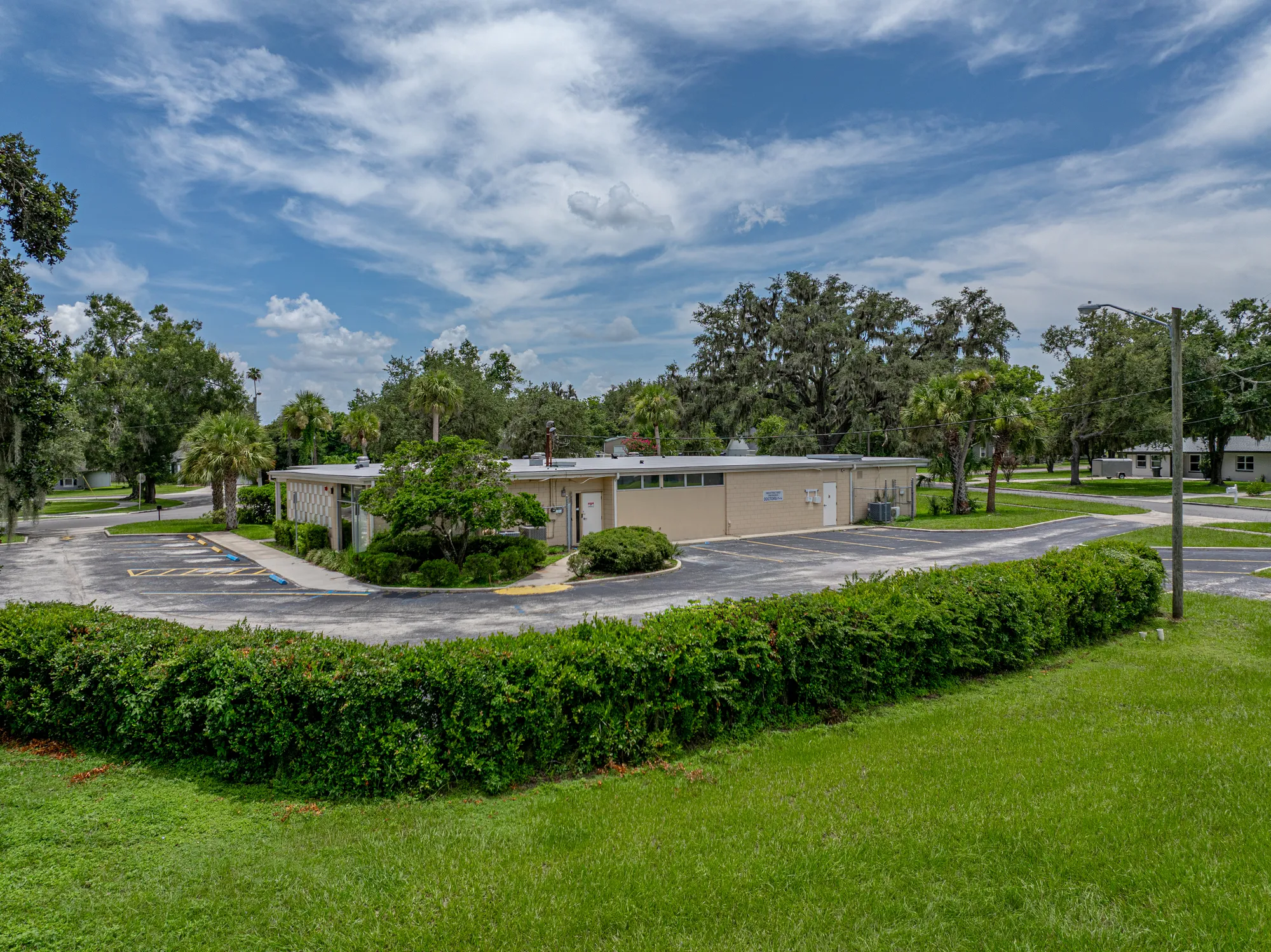 Single-story medical office building surrounded by palms and mature trees in Bartow, Florida